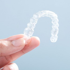 Patient holding clear aligner