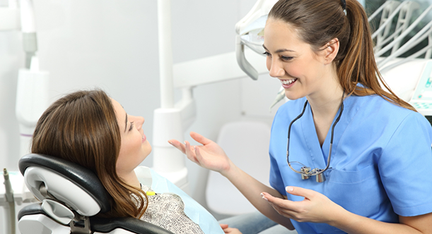 Female dentist talking to a female patient