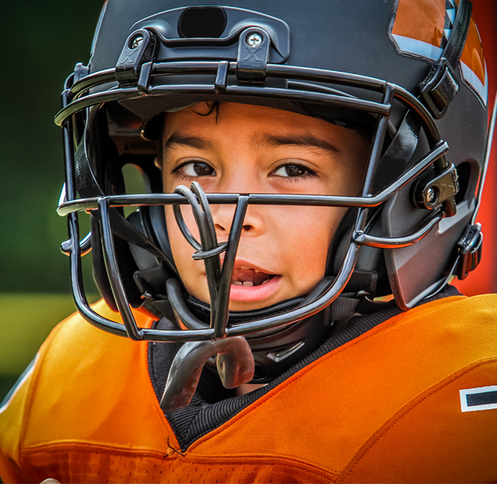 Small child wearing a football helmet