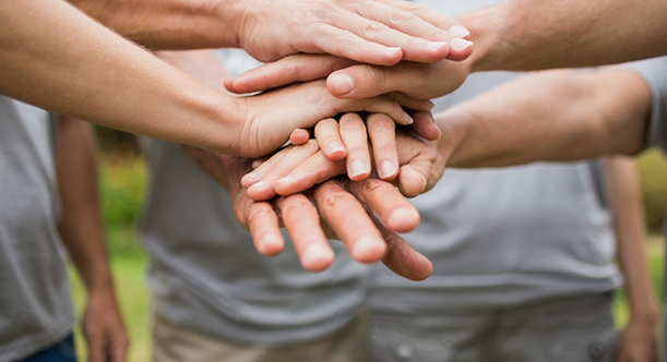 Man people in circle putting their hands together