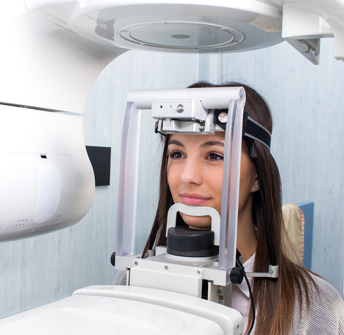 Woman about to have teeth scanned by cone beam scanner