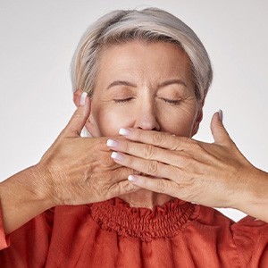 Lady conceals her teeth