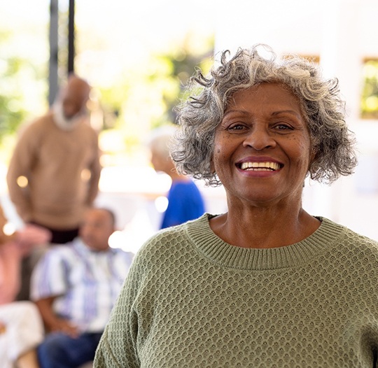 Closeup of woman smiling outside with friends