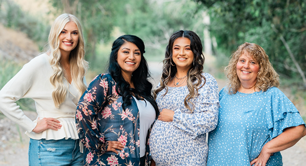 Dental team members standing together outside and smiling