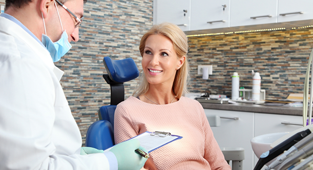 Female patient smiling at her dentist