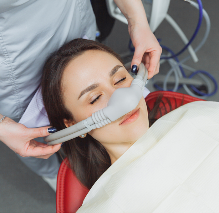 Placing nasal mask on female patients nose for sedation dentistry in Idaho Falls