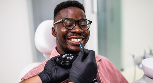 Man in dental chair having teeth shade matched for veneers in Idaho Falls